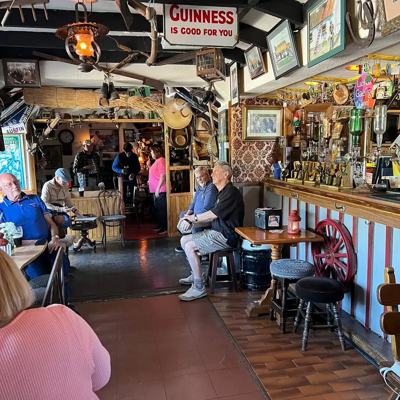 Interior of the pub showing antiques and old photographs on the walls around the bar